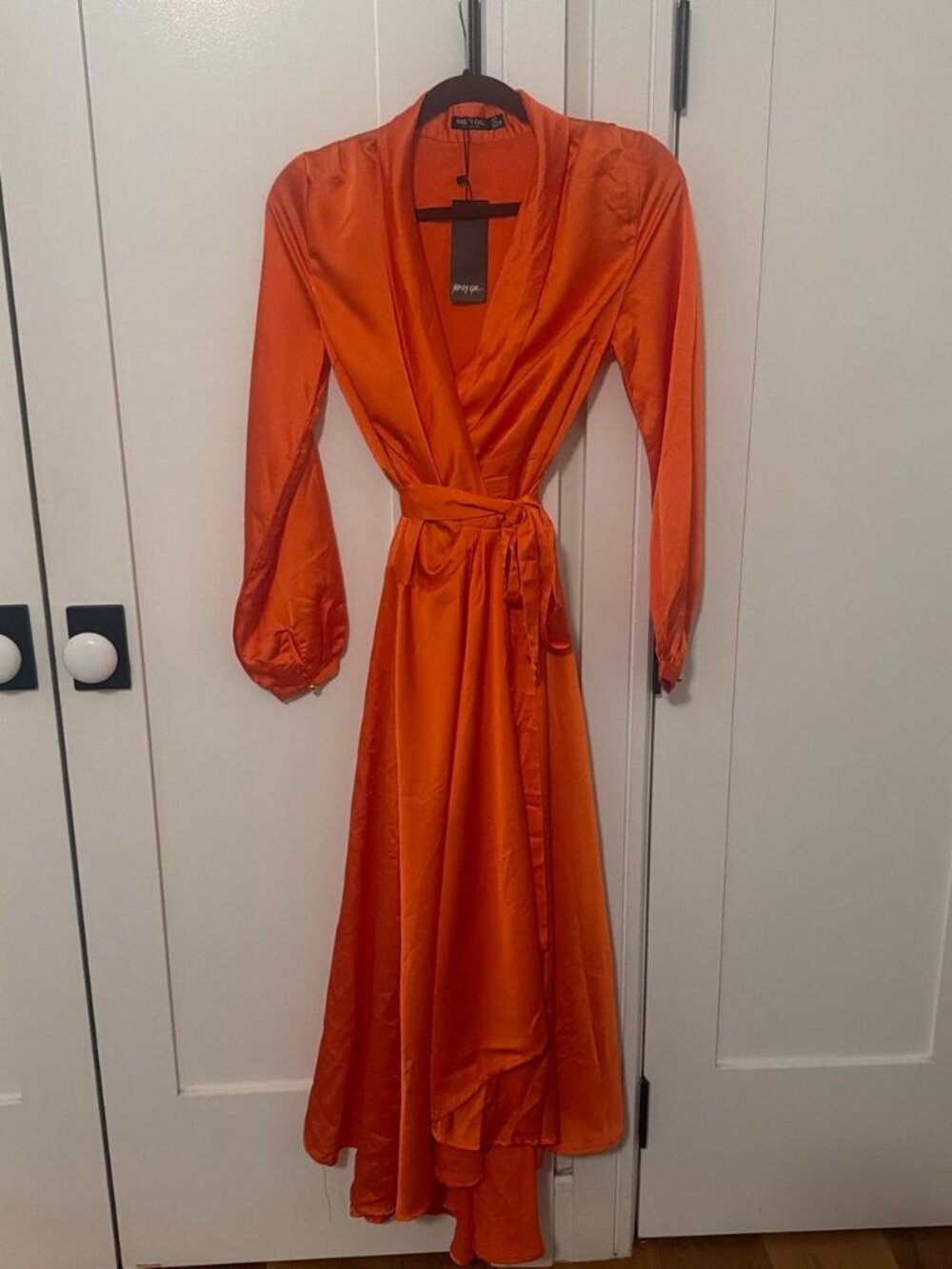 Orange wrap dress with tie waist and flowy skirt